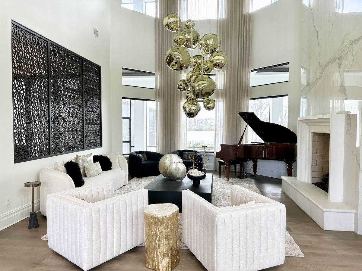 Grand salon with gold bubble chandelier and piano